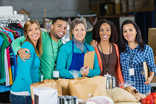 A group of happy workers posing for a photo at the local food bank